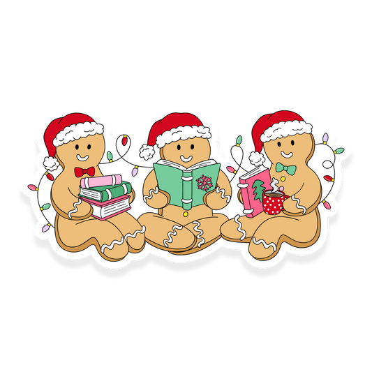 Three gingerbread characters in Santa hats reading books with Christmas lights around them.